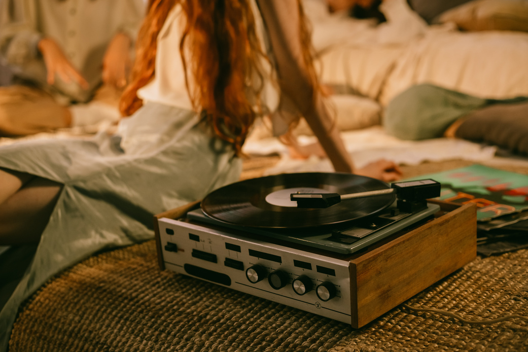 Vinyl Record Player and Women Listening to Music